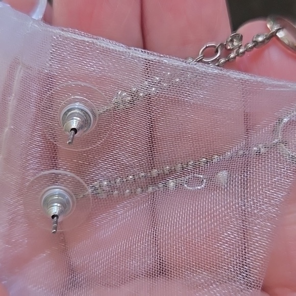 little silver earrings that have a diamond looking ring at the bottom - Picture 3 of 3